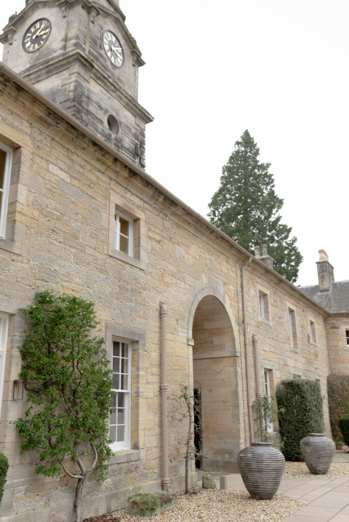 The beautiful entrance courtyard of Penicuik House, Penicuik Estate, Scotland — a private country estate wedding venue near Edinburgh. Image by renowned wedding photographer Scotland, Jill Cherry Porter, in connection with Scottish destination wedding planner, Emma Matthews founder of Timeless White Wedding Planning, and Jill Alexander, abundant wedding floral designer UK, The Little Flower Atelier.