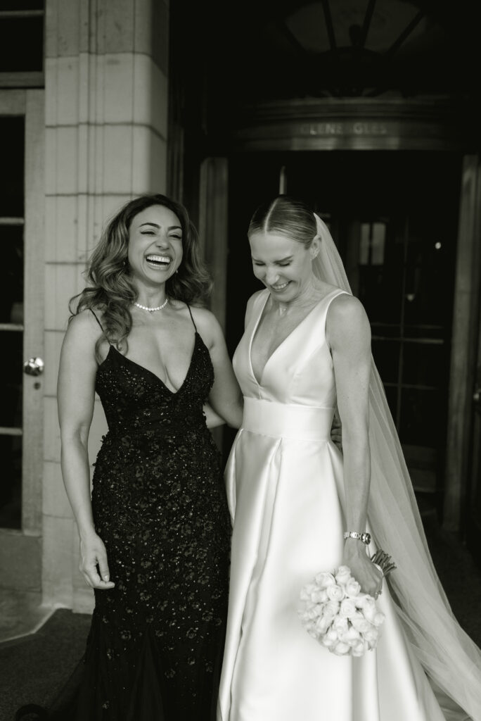 Bride enjoys a relaxed moment with her bridesmaid on her Gleneagles wedding day in Scotland.  Image by Gleneagles recommended photographer, Jill Cherry Porter.