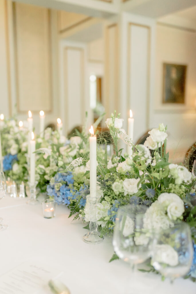 Blue, white and green hydrangea floral wedding table centre meadow and taper candles on a Gleneagles wedding day. Image by award winning fine art wedding photographer Scotland, Jill Cherry Porter.