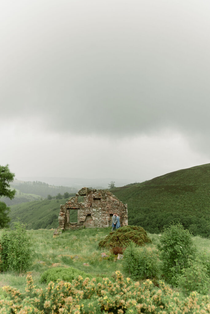 Couple enjoying the wild landscape of Scotland on their wedding day at Drumtochty Castle.  Planned by NOVU weddings, for Timeless White Wedding Planning. Image by award winning luxury wedding photographer in Scotland, Jill Cherry Porter.