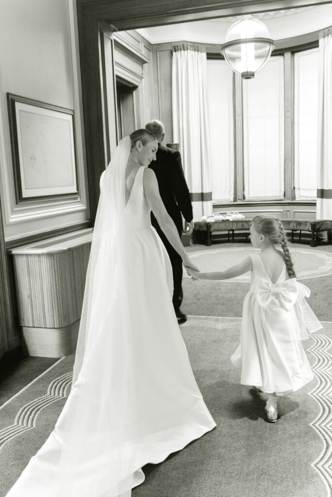 Bride and Groom stroll happily through the spaces of the Gleneagles Hotel on their wedding day. Image by award winning luxury Gleneagles wedding photographer, Jill Cherry Porter.