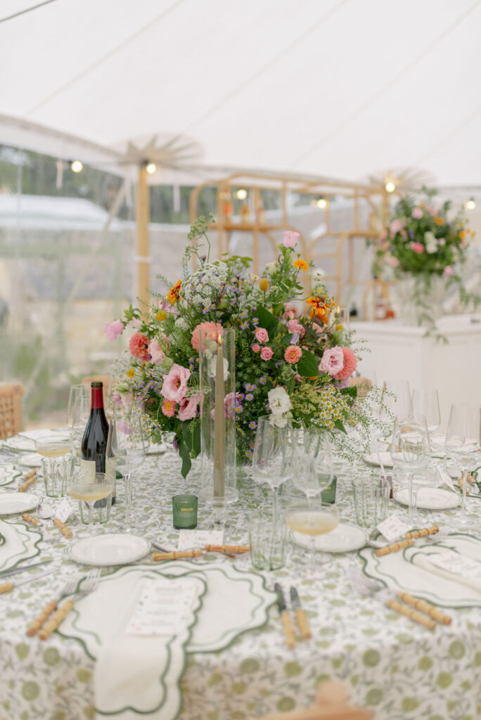 Botanical patterned wedding tablecloth and floral table setting with flowers by Wild Flowers Edinburgh, in a sailcloth tent marquee for a multi day wedding on Penicuik Estate. Planned by Scotland wedding planner Coleen McKay weddings. Image by award winning luxury wedding photographer in Scotland, Jill Cherry Porter.