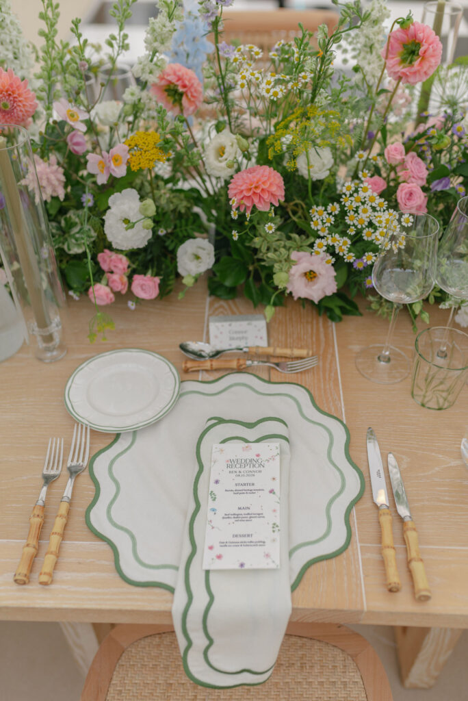 Botanical layered floral table setting design by Wild Flowers Edinburgh, in a sailcloth tent marquee on Penicuik Estate. Planned by Scotland wedding planner Coleen McKay weddings. Image by award winning luxury wedding photographer in Scotland, Jill Cherry Porter.