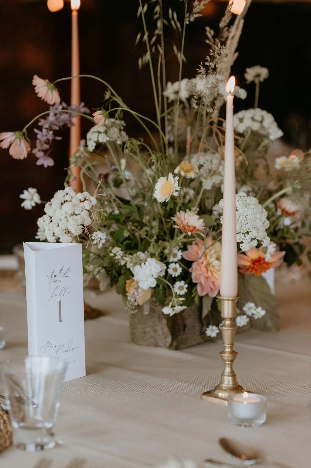 Delicate table florals and taper candles in pastel colours, wedding planning by Clementine Weddings, one of the best wedding planners in the uk and Scotland.