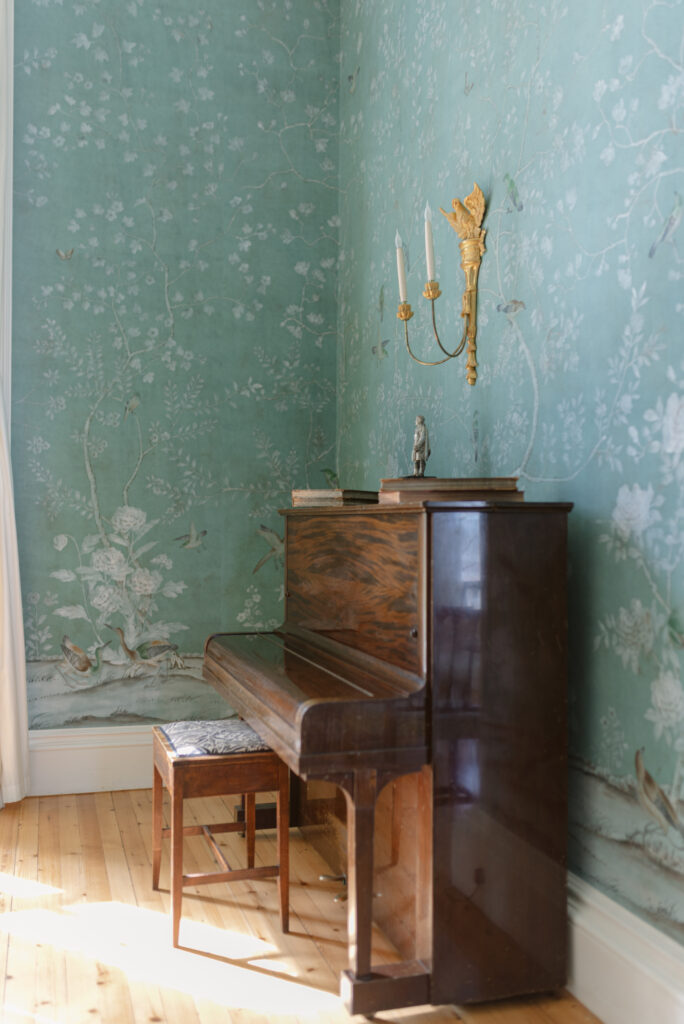 Piano and hand-painted wallpaper within the drawing room of Birkhill Castle private wedding venue, Scotland. Image by Scottish wedding photographer Jill Cherry Porter.