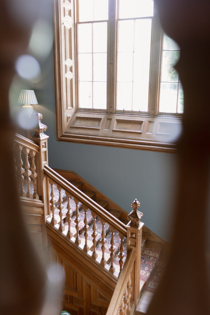 Traditional staircase inside the house, very Downton Abbey in feel