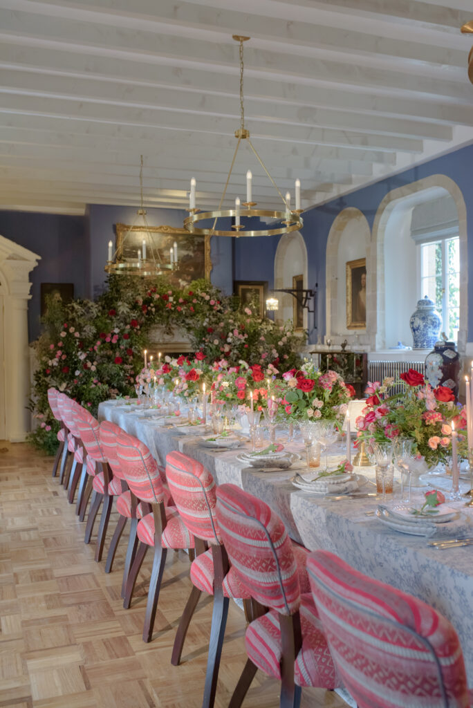 Abundant floral private estate wedding reception design at Penicuik House with long table, floral installation and blue patterned linens