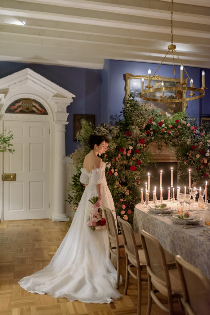 Bride and Groom take in reception table at their wedding in Penicuik House, featuring wedding floral installation by The Little Flower Atelier, Chatsworth Linens by Chateau Noir Event Hire and Splendid Hire tableware, in Penicuik Estate, Scotland. Wedding photography by Jill Cherry Porter. 
