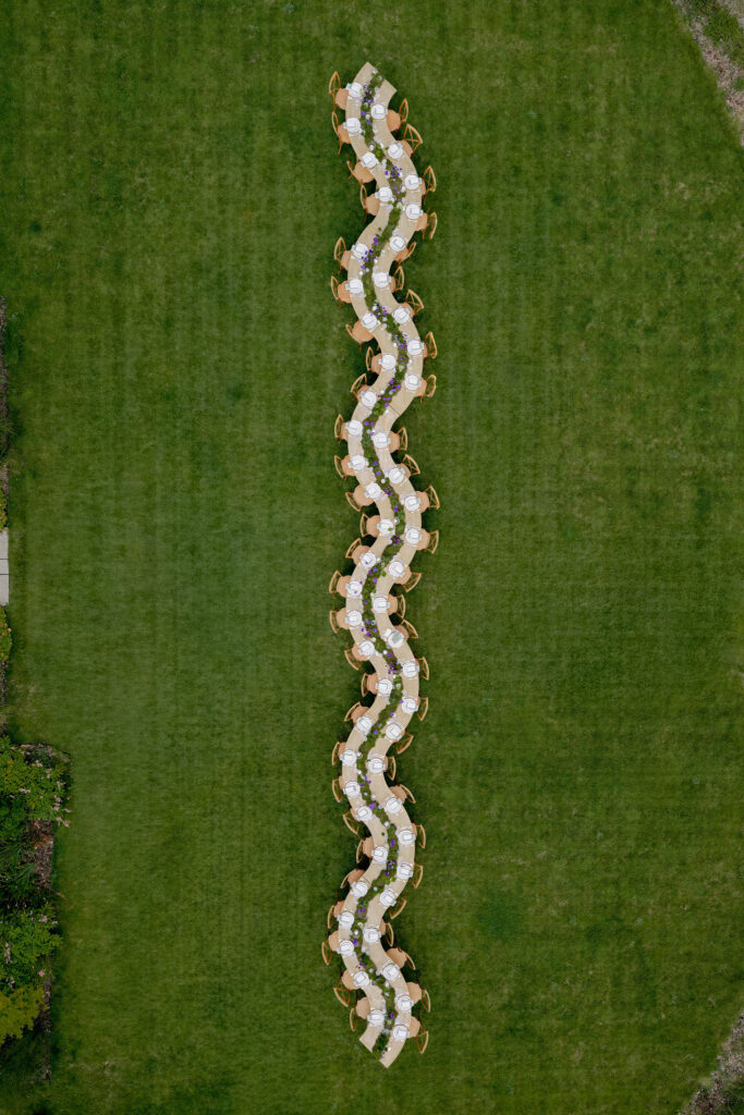 Overhead view of serpentine table at Eskfield on Penicuik Estate, Scotland destination wedding venue. Image by Penicuik House recommended wedding photographer, Jill Cherry Porter.