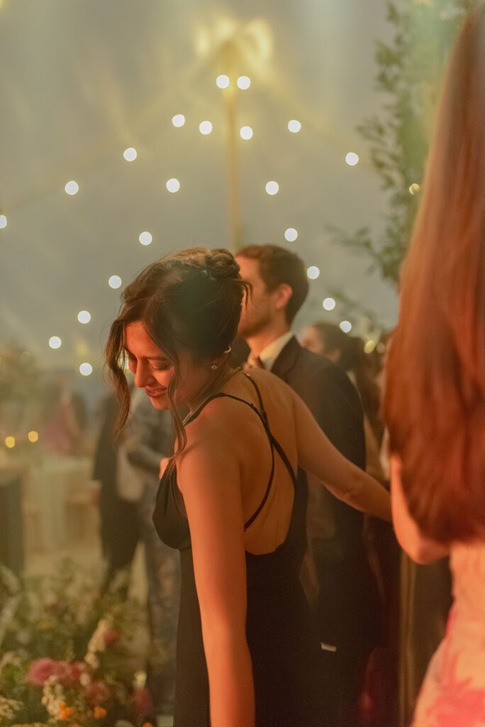 Guests dancing at wedding reception celebration in a sailcloth tent on Penicuik Estate, Scotland destination wedding venue. Image by Penicuik House recommended wedding photographer, Jill Cherry Porter.