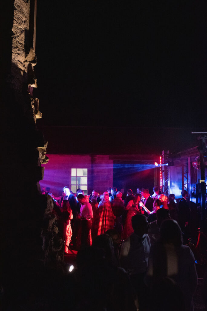 Wedding after-party in the old ruins of Penicuik House on Penicuik Estate, Scotland destination wedding venue. Image by Penicuik House recommended wedding photographer, Jill Cherry Porter.