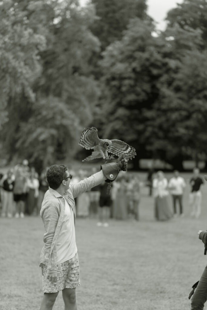 Live falconry during wedding welcome event at Penicuik Estate, Scotland destination wedding venue. Image by Penicuik House recommended wedding photographer, Jill Cherry Porter.