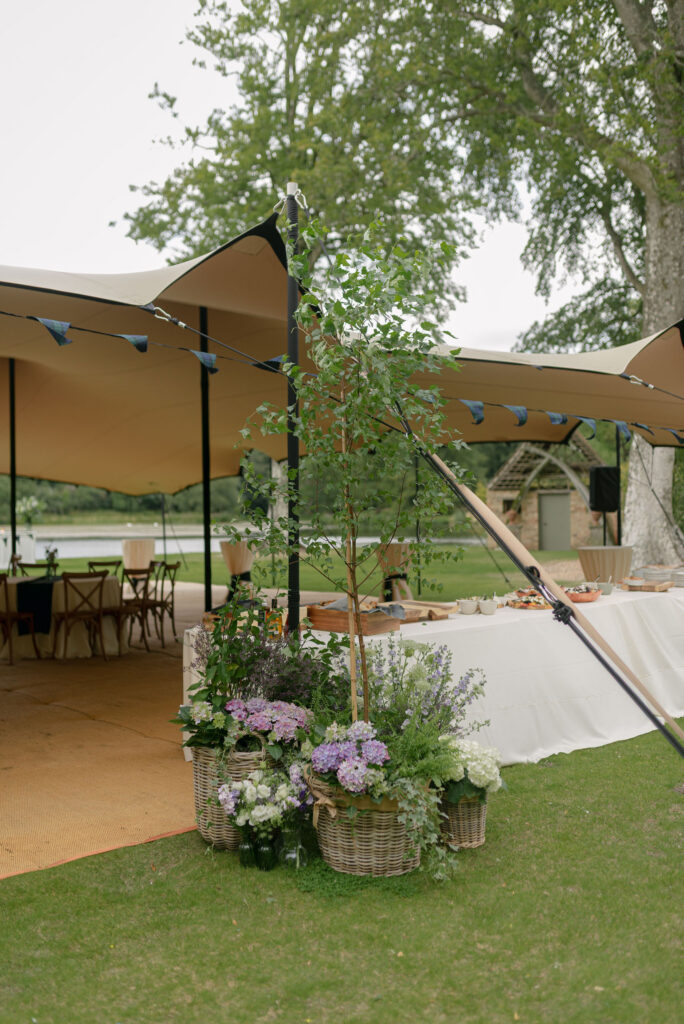 Floral design at drinks reception by the High Pond on Penicuik Estate, Scotland destination wedding venue. Image by Penicuik House recommended wedding photographer, Jill Cherry Porter.