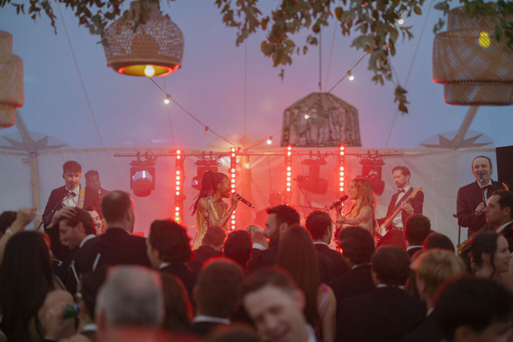 ALR Music perform at wedding reception celebration in a sailcloth marquee on Penicuik Estate, Scotland destination wedding venue. Image by Penicuik House recommended wedding photographer, Jill Cherry Porter.