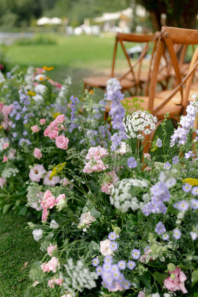 Floral meadows at ceremony setting by High Pond on Penicuik Estate, Scotland destination wedding venue. Image by Penicuik House recommended wedding photographer, Jill Cherry Porter.
