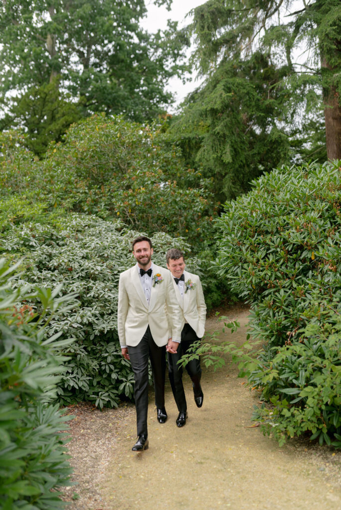 Couple walk through the grounds of Penicuik Estate, Scotland destination wedding venue, on their wedding day. Image by Penicuik House recommended wedding photographer, Jill Cherry Porter.