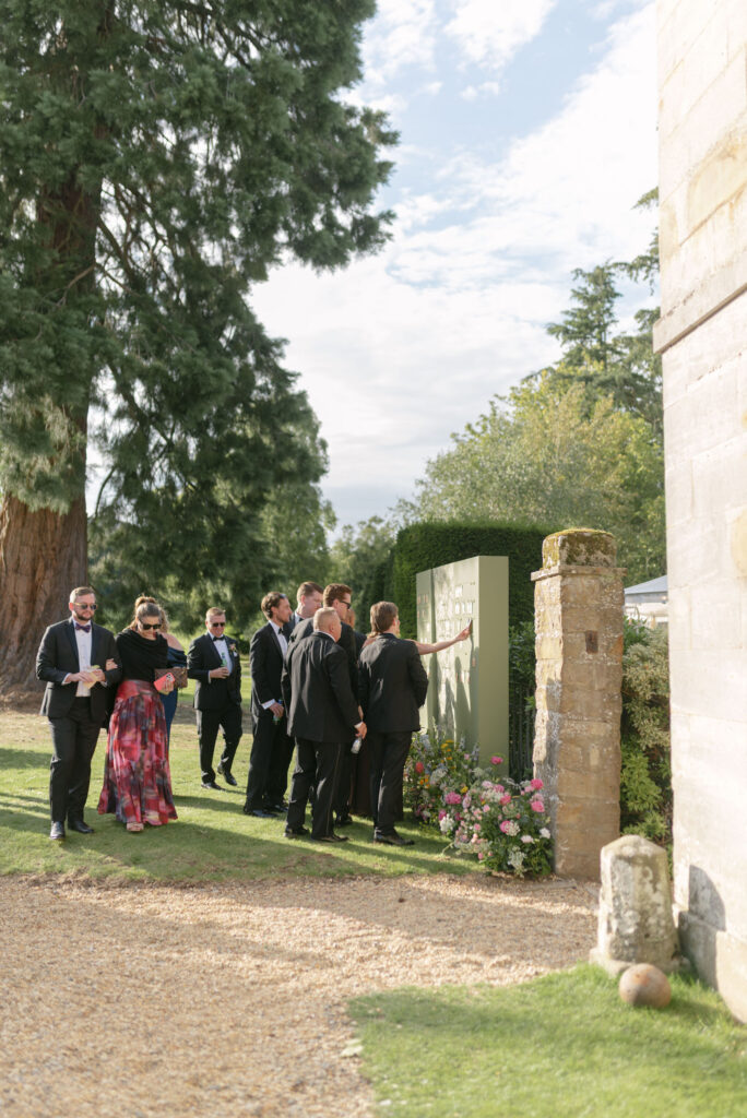 Guests select their seats from seed escort display on Penicuik Estate, Scotland destination wedding venue. Image by Penicuik House recommended wedding photographer, Jill Cherry Porter.